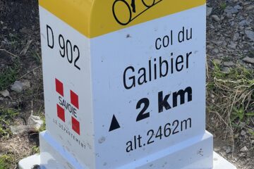 A classic distance marker showing 2km to the top of the Col du Galibier